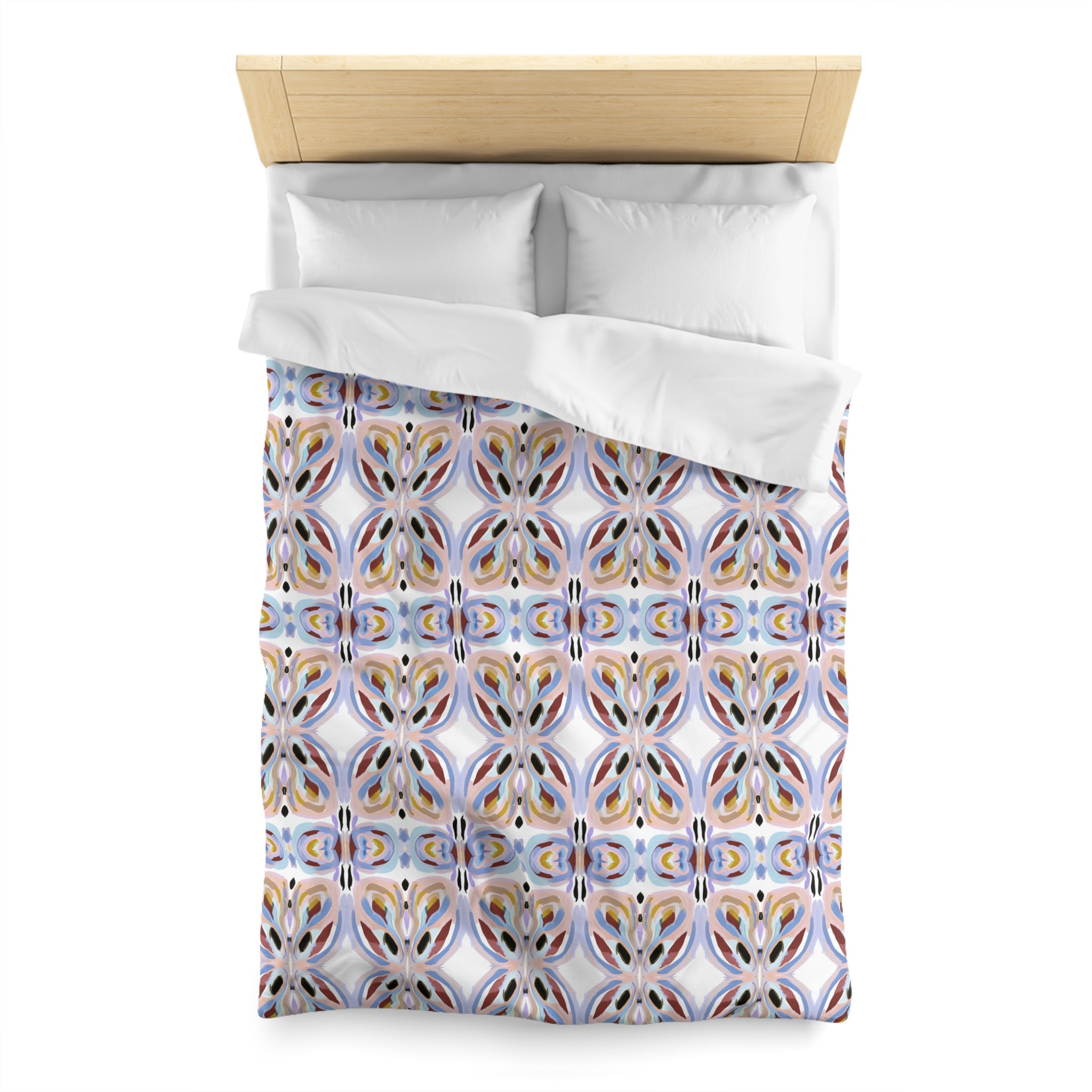 a bed with a colorful, patterned comforter and pillows.