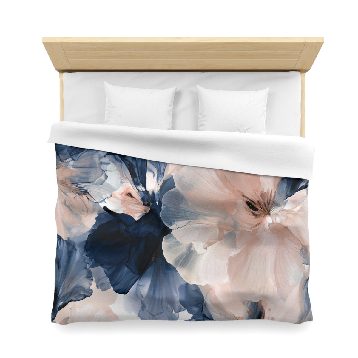 a bed with a floral comforter and pillows
