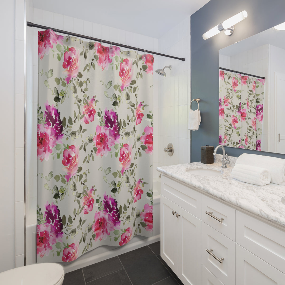 A bathroom with a white vanity, a floral shower curtain, and a mirror above the sink.