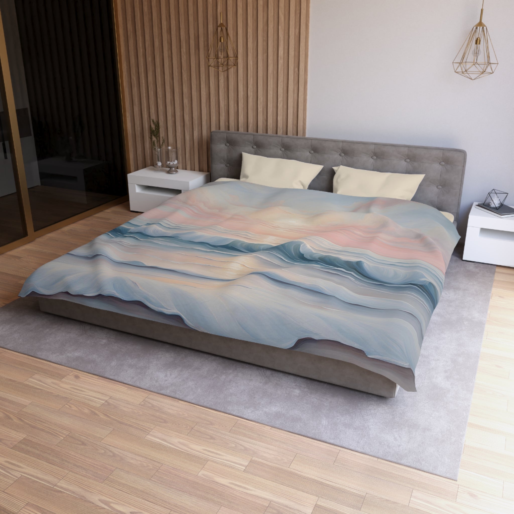a modern bedroom with a large bed, a gray headboard, and a colorful patterned comforter. The room has a wooden floor and white walls, creating a serene and stylish atmosphere.