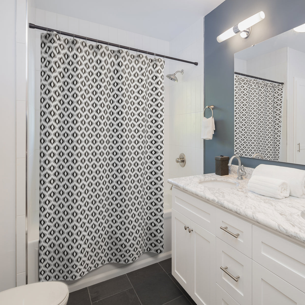 a modern bathroom with a white vanity, a black and white patterned shower curtain, and a mirror above the vanity.