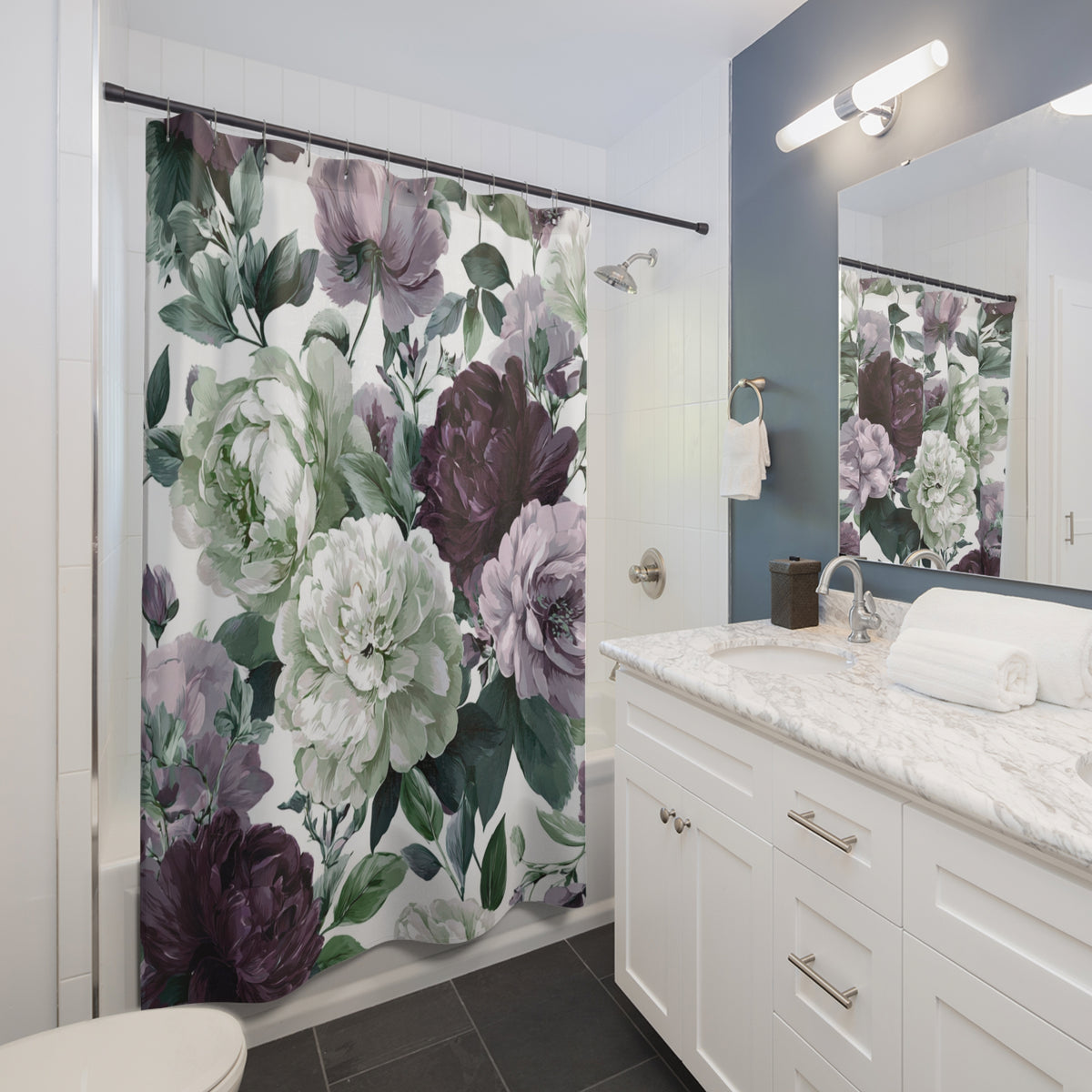 a bathroom with a white vanity and a shower curtain featuring a floral pattern in shades of purple and green.