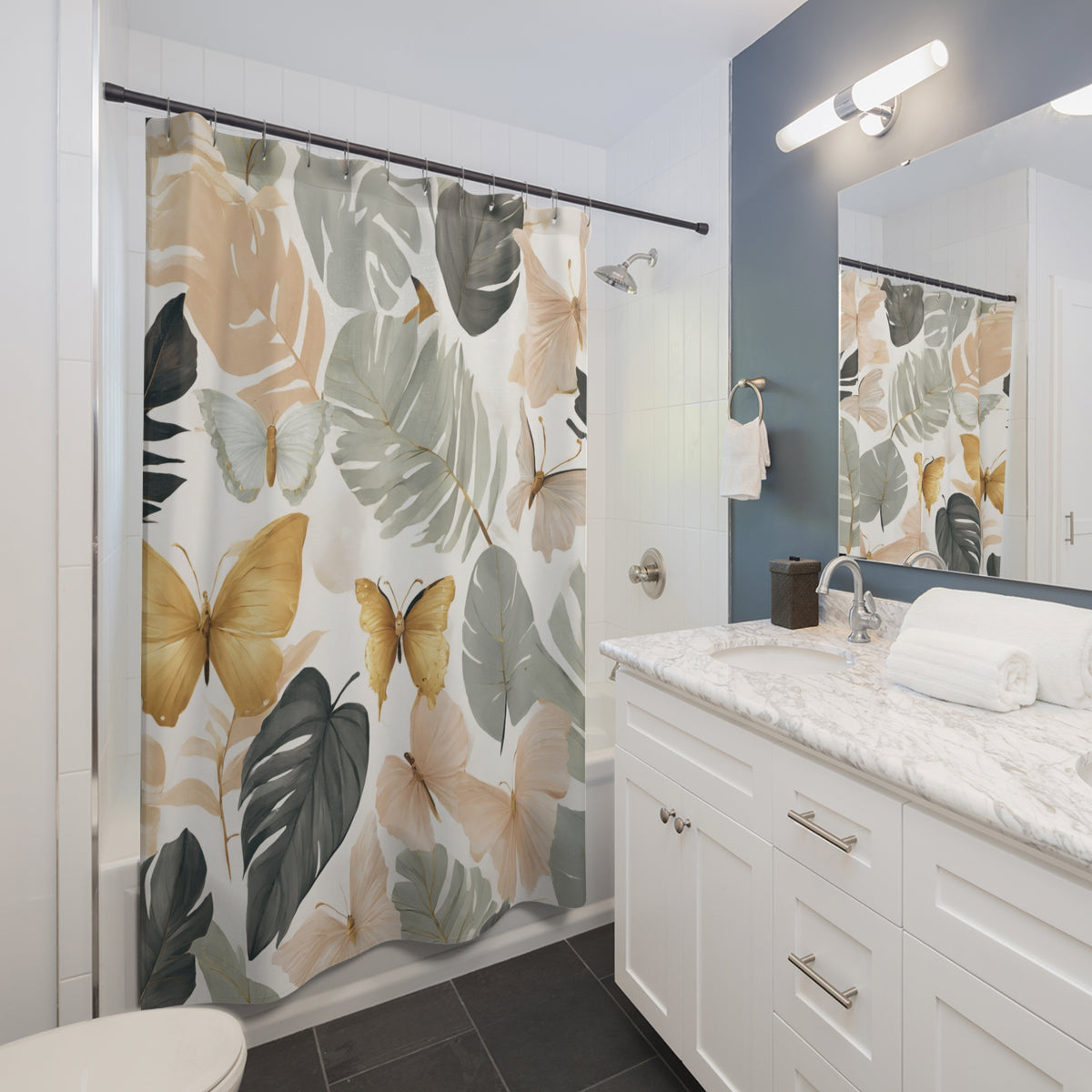 a bathroom with a shower curtain featuring a tropical leaf pattern in shades of green, yellow, and brown. The bathroom has white cabinets, a marble countertop, and a sink with a mirror above it.