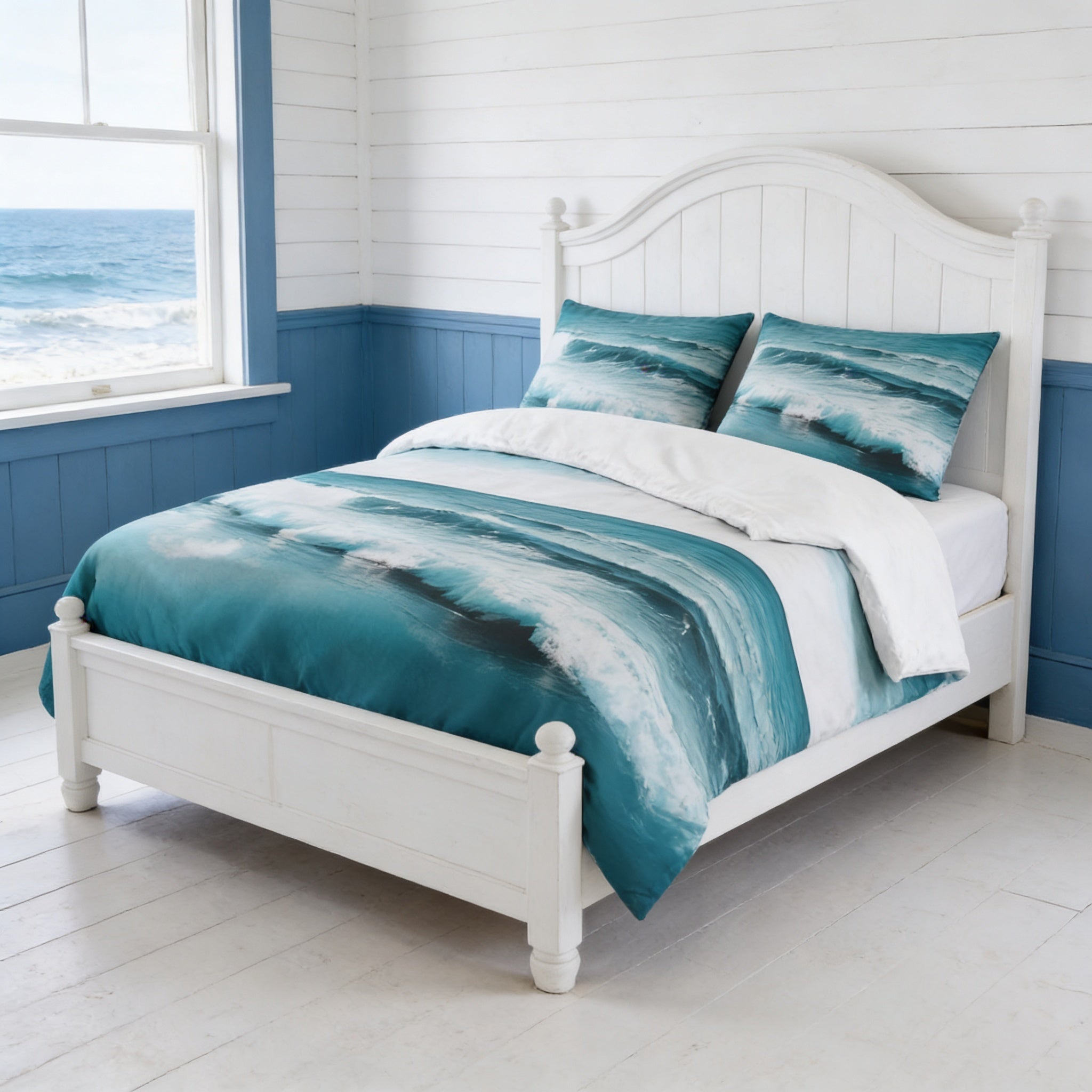 a white wooden bed with a blue and white ocean-themed comforter and pillows, positioned in front of a window overlooking the ocean.