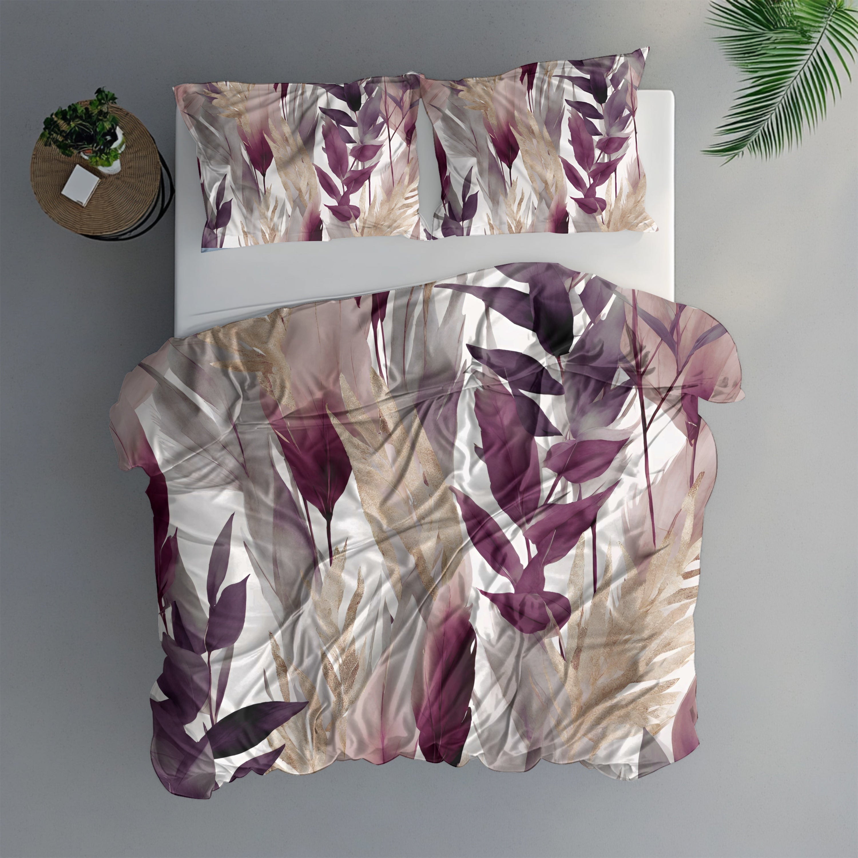 a bed with a floral print duvet cover and matching pillows, placed on a gray floor. There is a small round table next to the bed with a plant on it.
