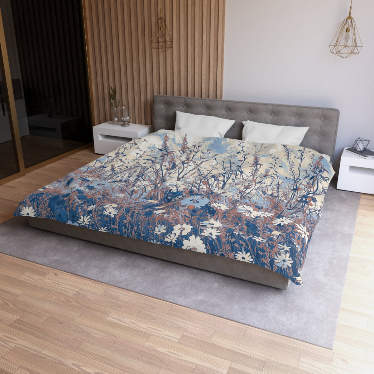 a modern bedroom with a large bed featuring a blue and white floral patterned comforter. The bed is positioned against a wall with a wooden panel, and there are two nightstands on either side of the bed. The room has a wooden floor and a gray area rug, creating a cozy and stylish atmosphere.