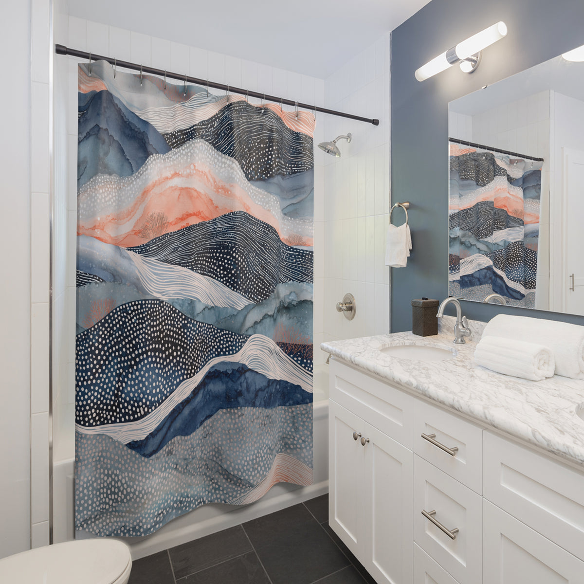 a modern bathroom with a white vanity, a large blue and white mountain-themed shower curtain, and a mirror above the vanity.
