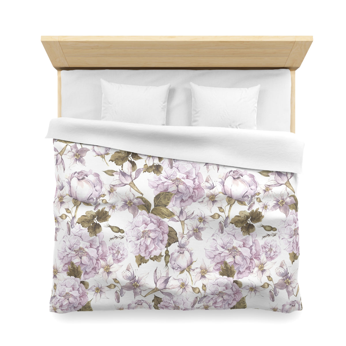 a neatly made bed with a floral print comforter and pillows.