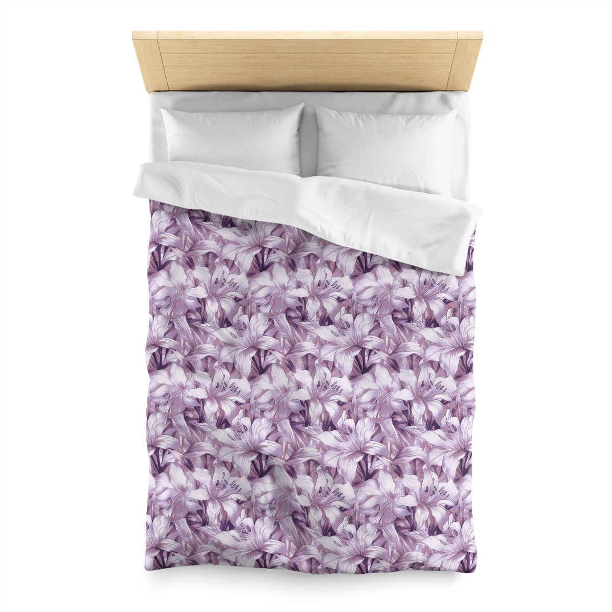 a bed with a purple floral patterned comforter and pillows.