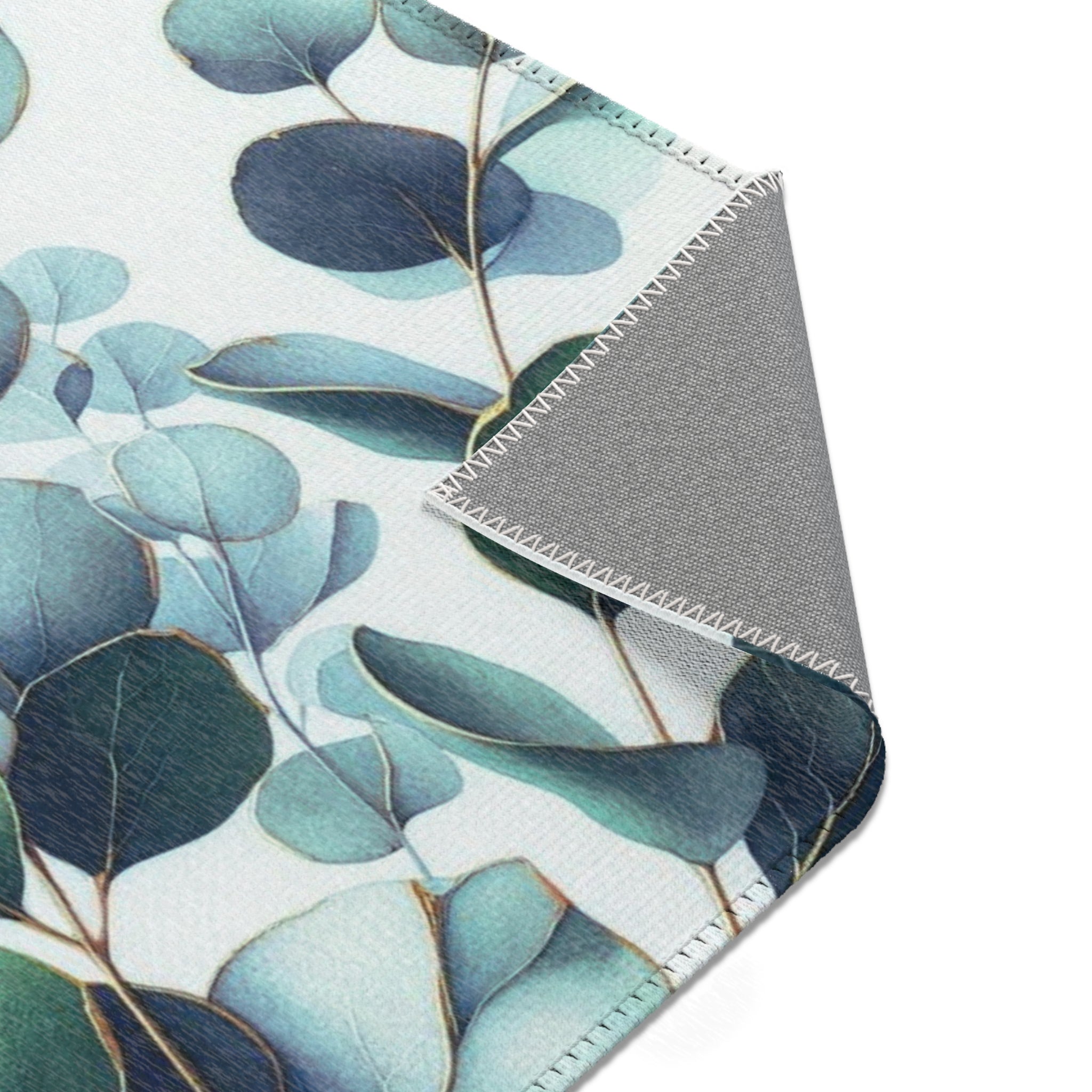 a close-up view of a fabric with a leafy, plant-like pattern in shades of blue and green.