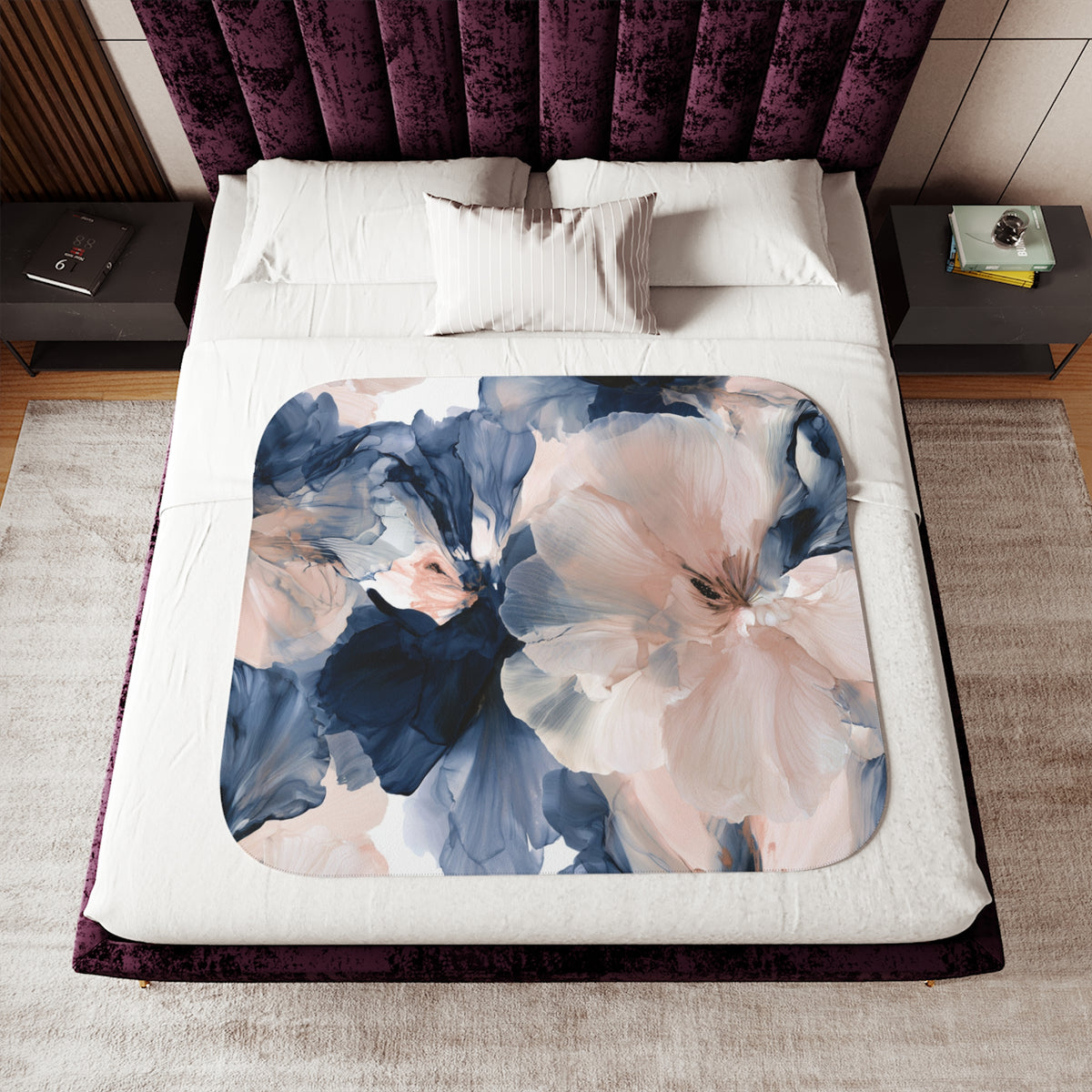 a bed with a floral comforter and pillows