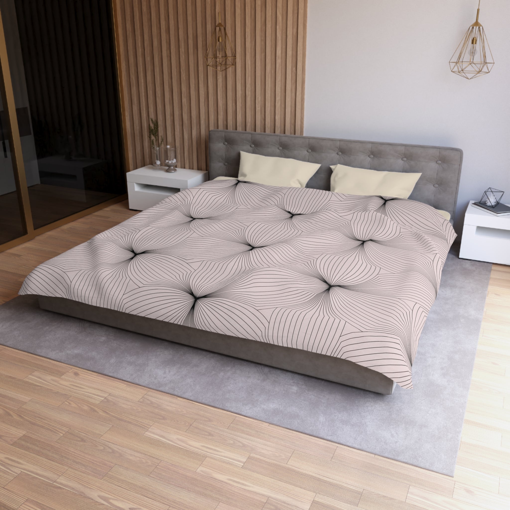 a modern bedroom with a large bed, a gray headboard, and a patterned comforter. The room has a wooden floor and white walls, creating a clean and minimalist aesthetic.