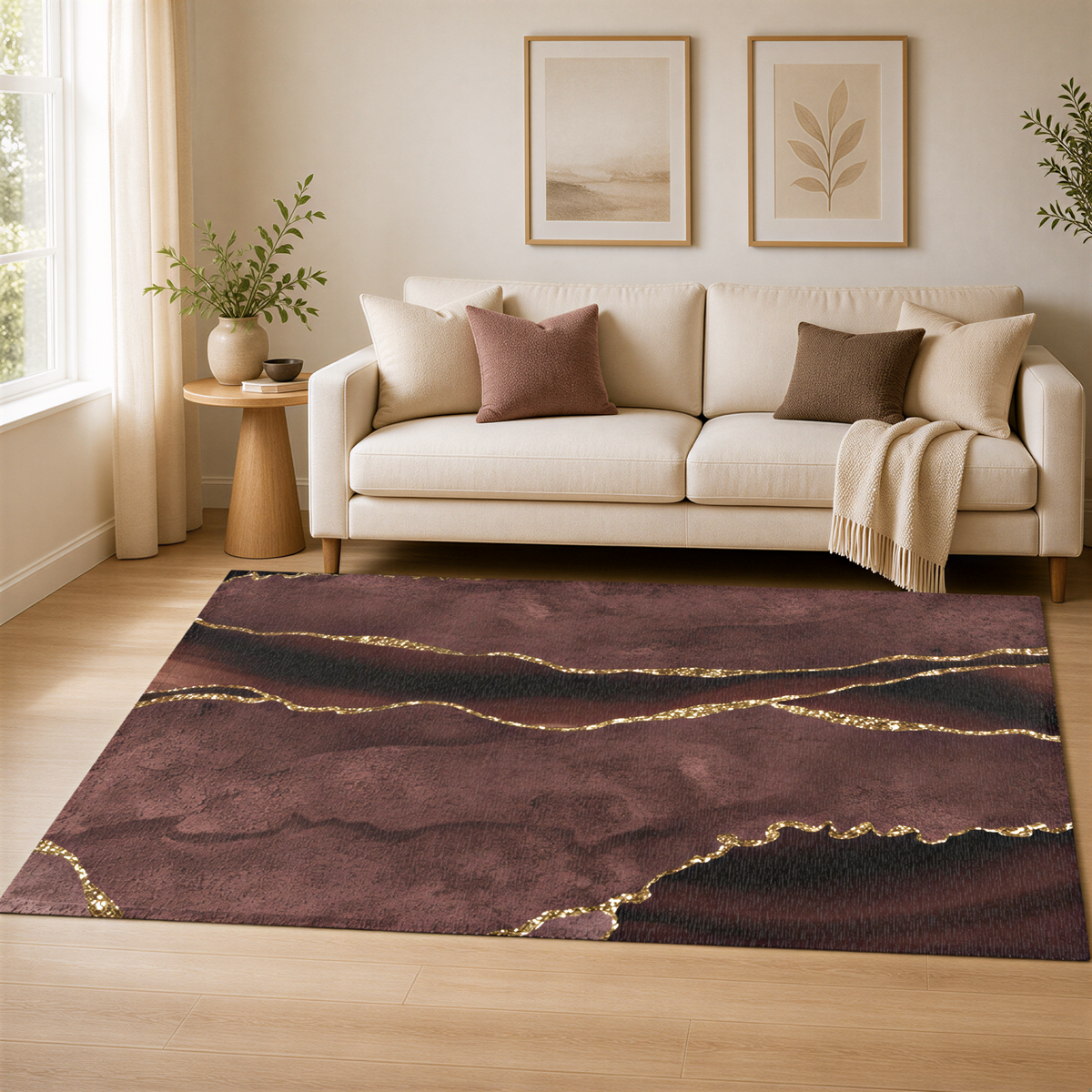 a living room with a white sofa, a large abstract rug with a maroon and gold color scheme, and framed pictures on the wall.