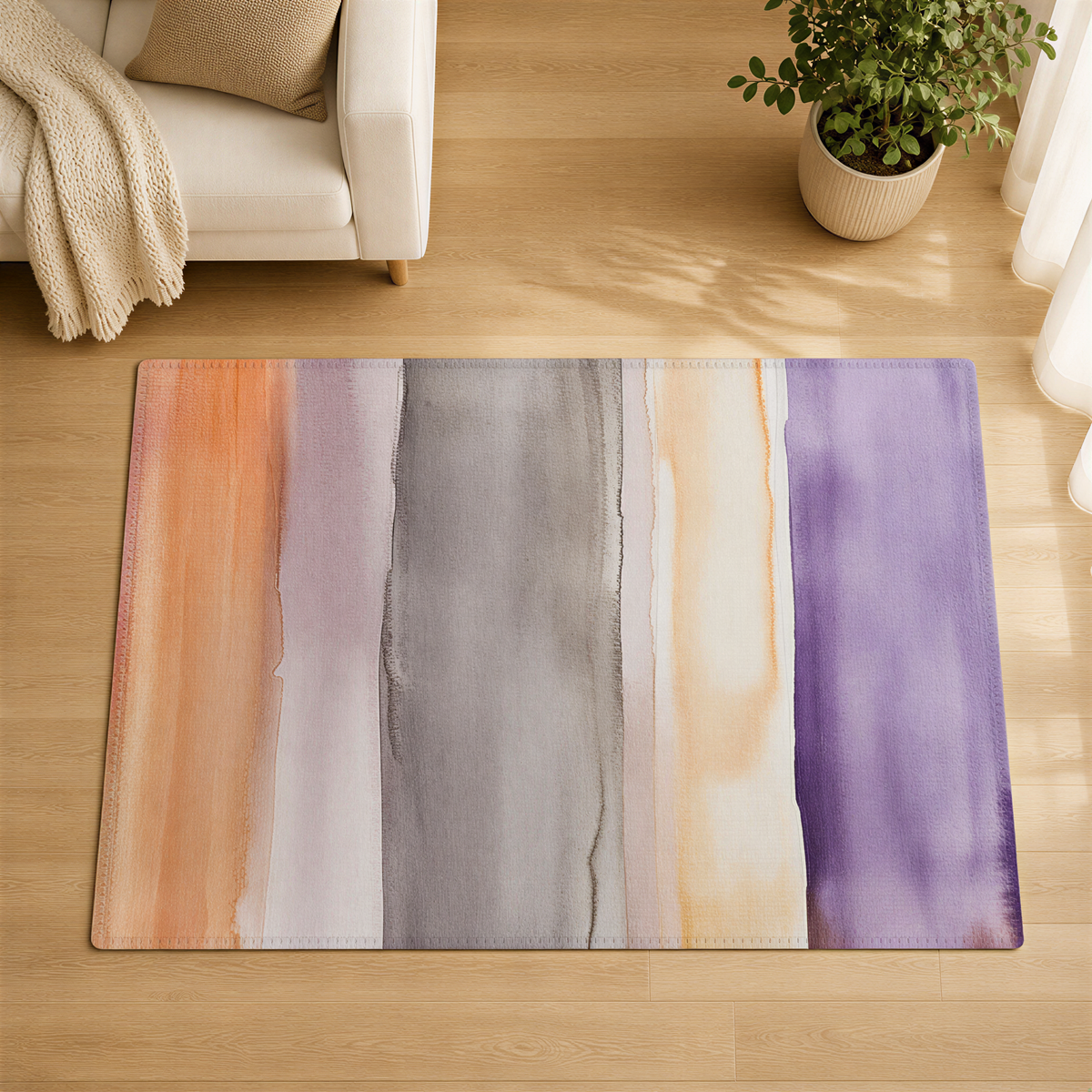 a living room with a colorful abstract rug on the floor, a white couch, and a potted plant.