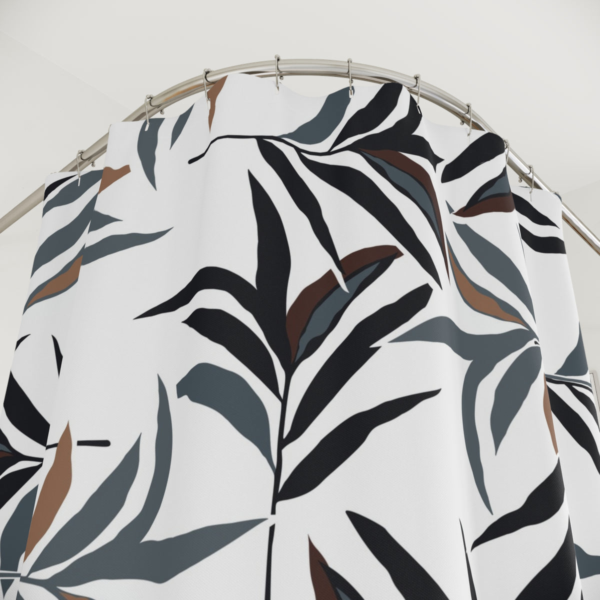 a shower curtain with a black and white leaf pattern.