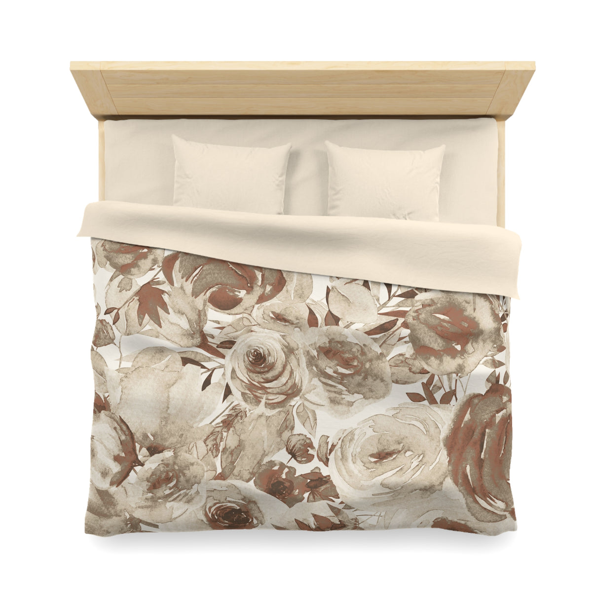 a neatly made bed with a floral print comforter and two pillows.