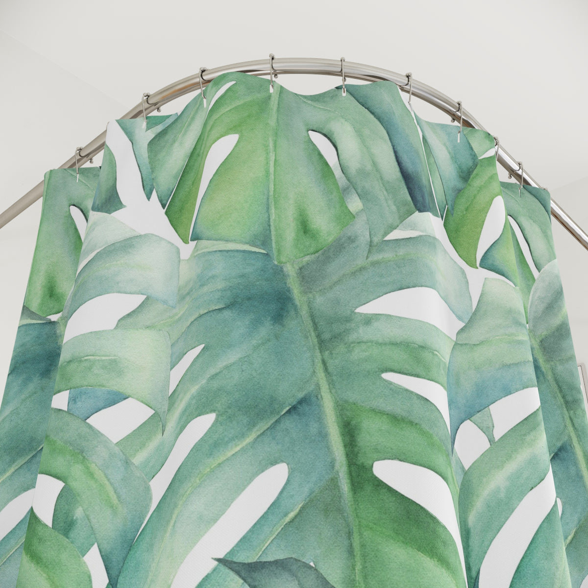 a shower curtain with a large, vibrant green leaf pattern.