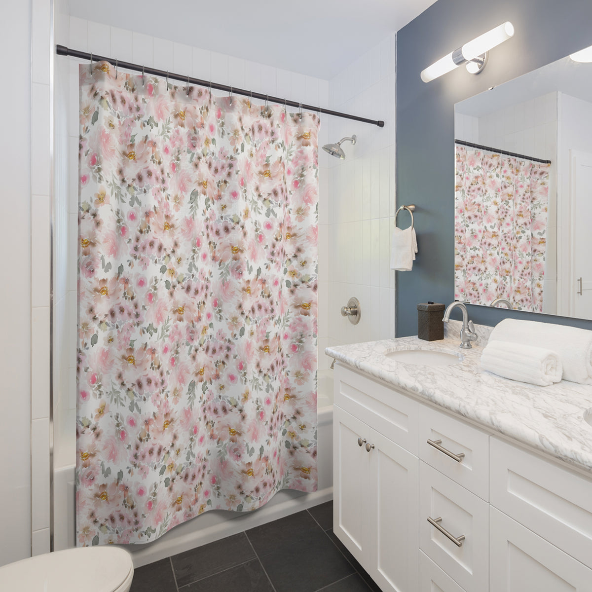 A modern bathroom with a white vanity, a floral patterned shower curtain, and a mirror above the sink.