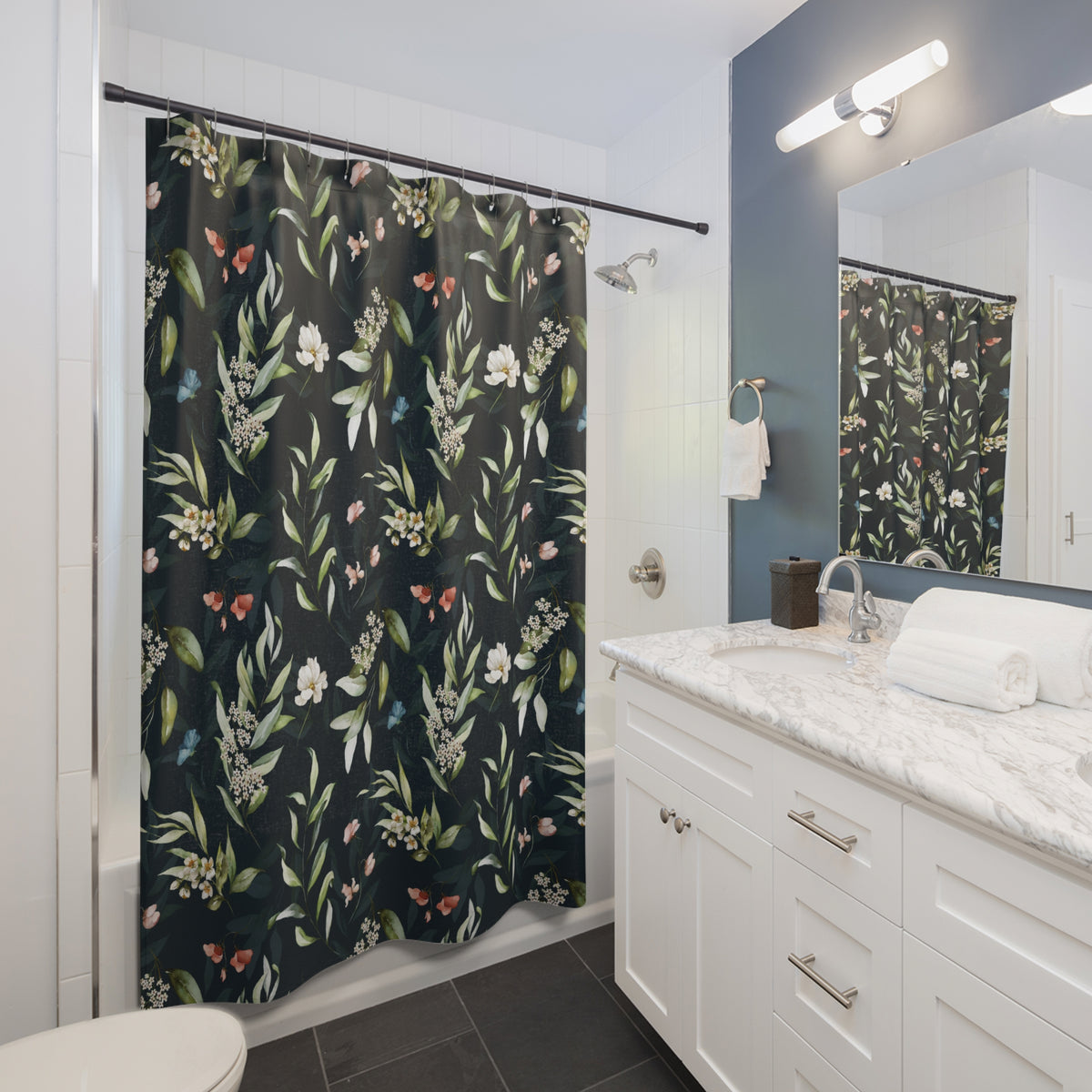 a modern bathroom with a white vanity, a black and white floral shower curtain, and a white countertop.