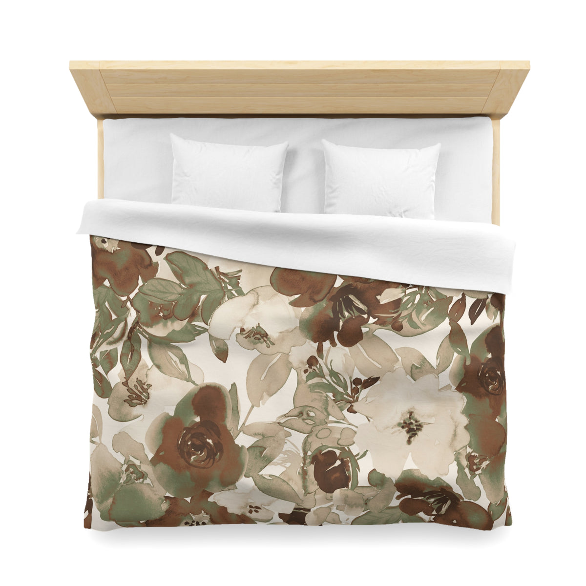 a neatly made bed with a floral print comforter and two white pillows.