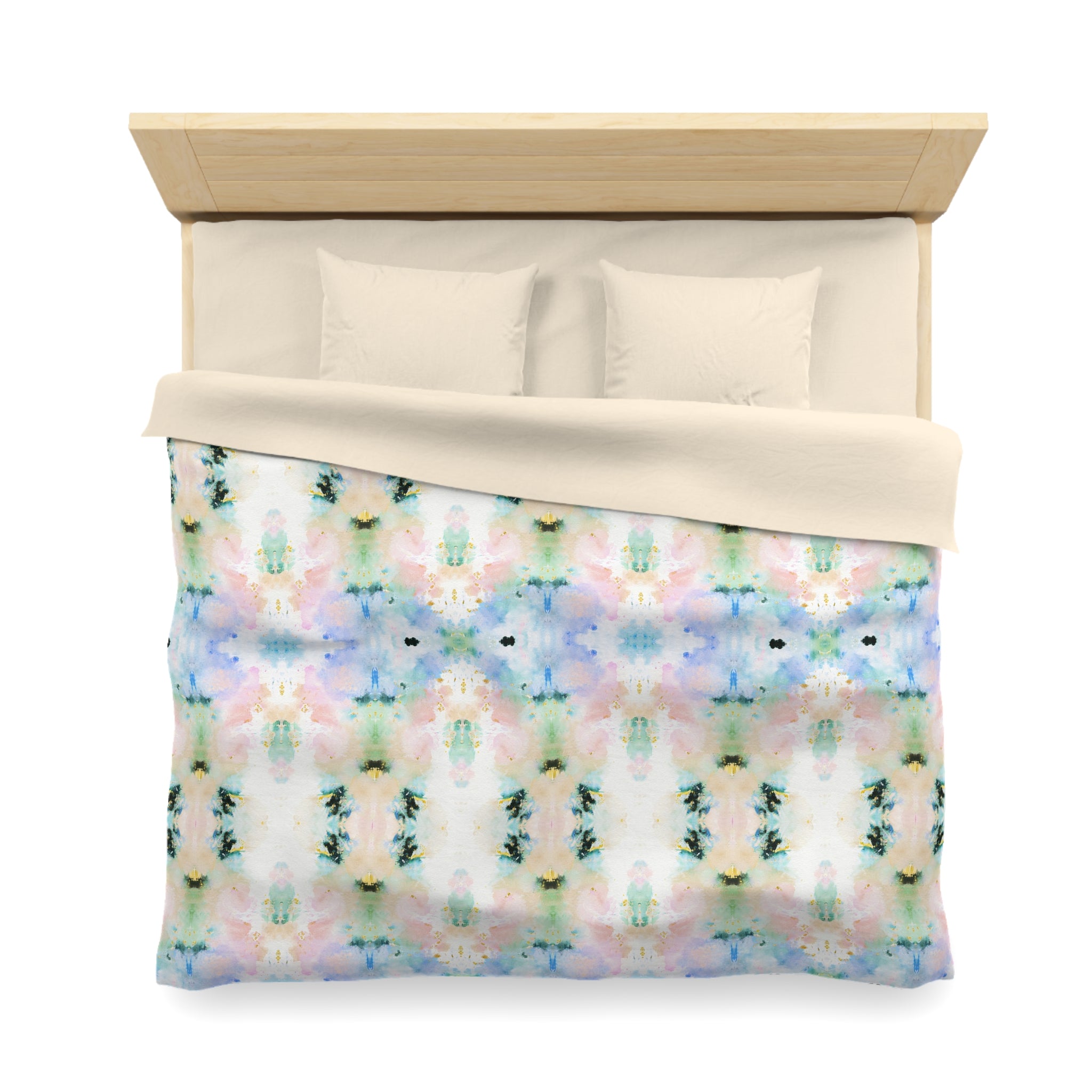 a bed with a colorful, abstract patterned comforter and pillows.