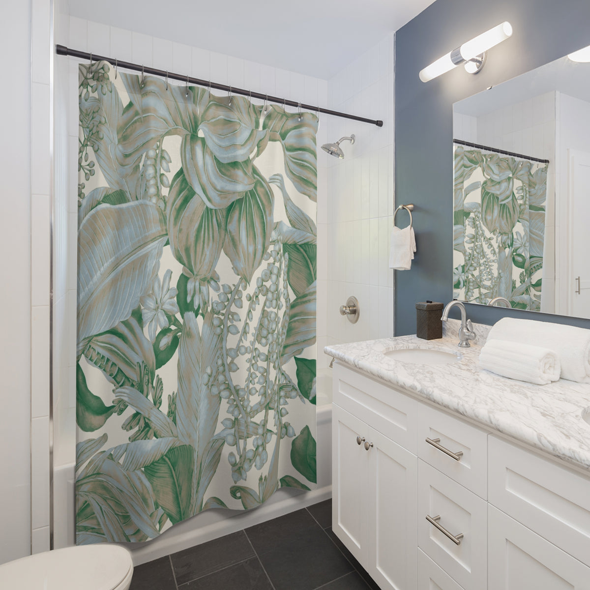 a modern bathroom with a white vanity, a large green and white shower curtain featuring a tropical plant design, and a mirror above the vanity.