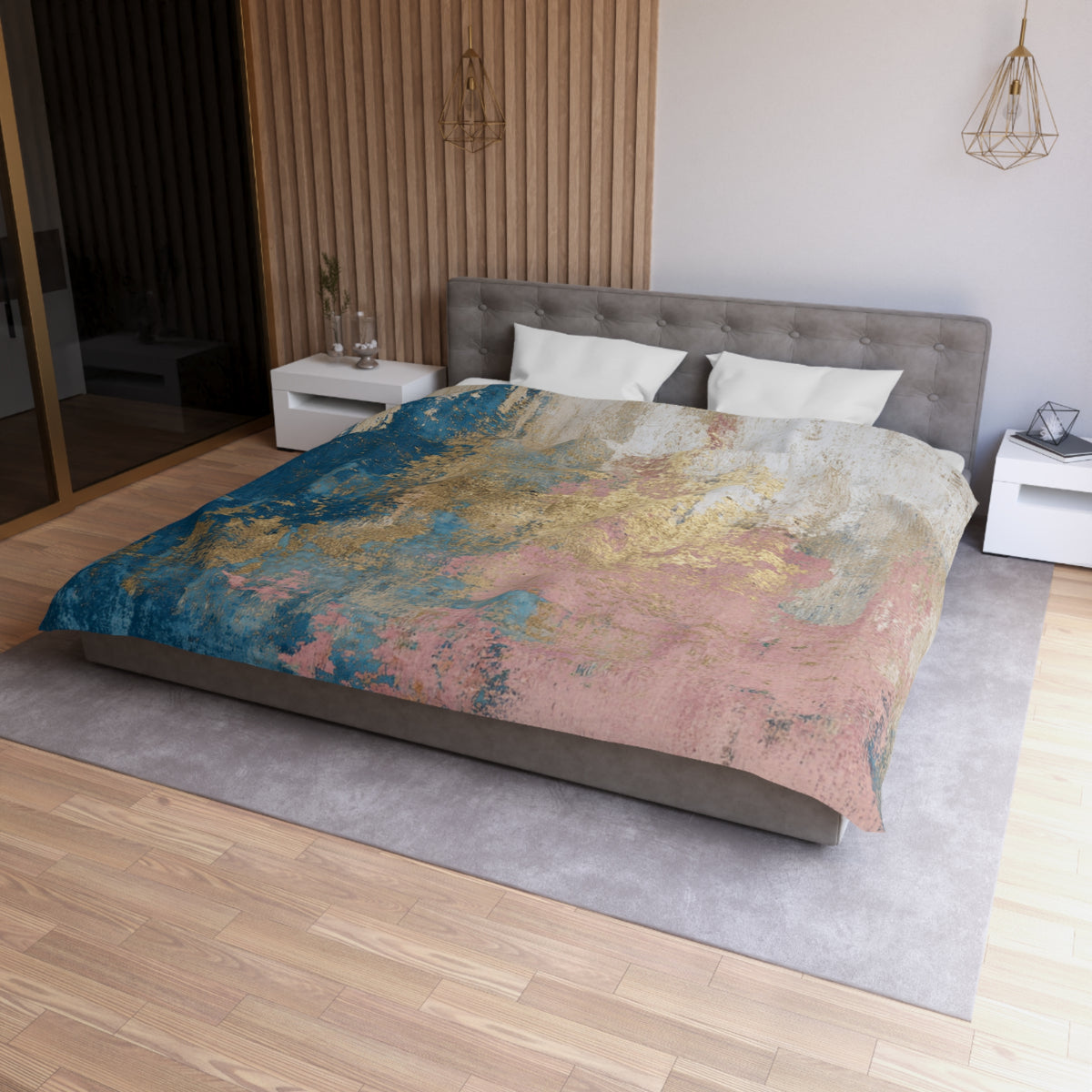 a modern bedroom with a large bed covered in a colorful, abstract-patterned comforter. The bed is positioned against a wall with a wooden panel, and there are two nightstands on either side of the bed. The room has a minimalist and contemporary design, with a gray headboard and a wooden floor.