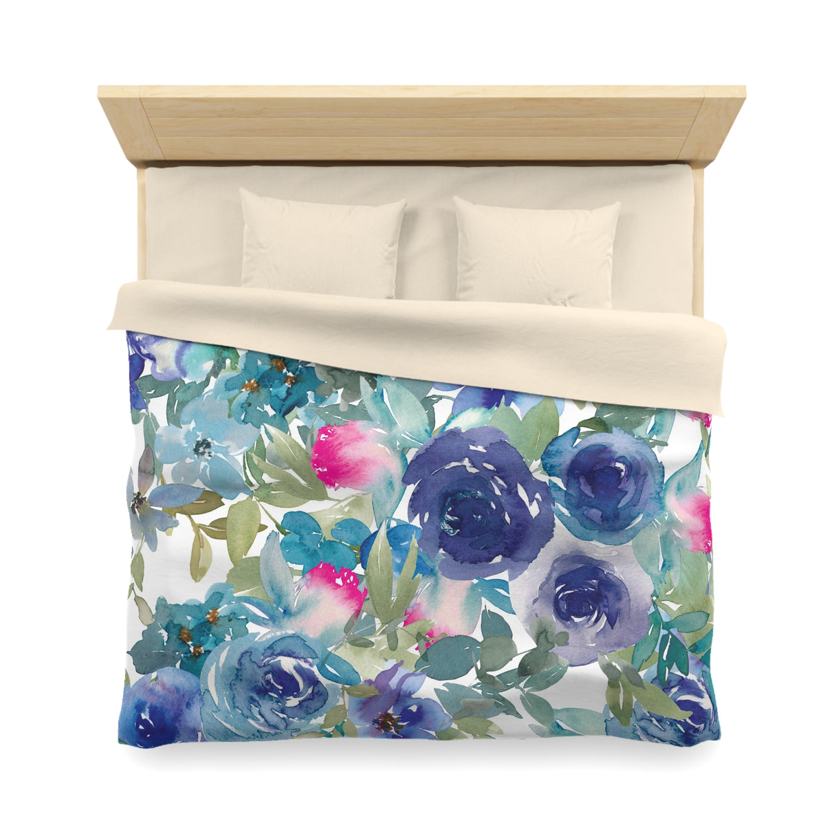a bed with a floral print duvet cover featuring blue, pink, and green flowers and leaves.