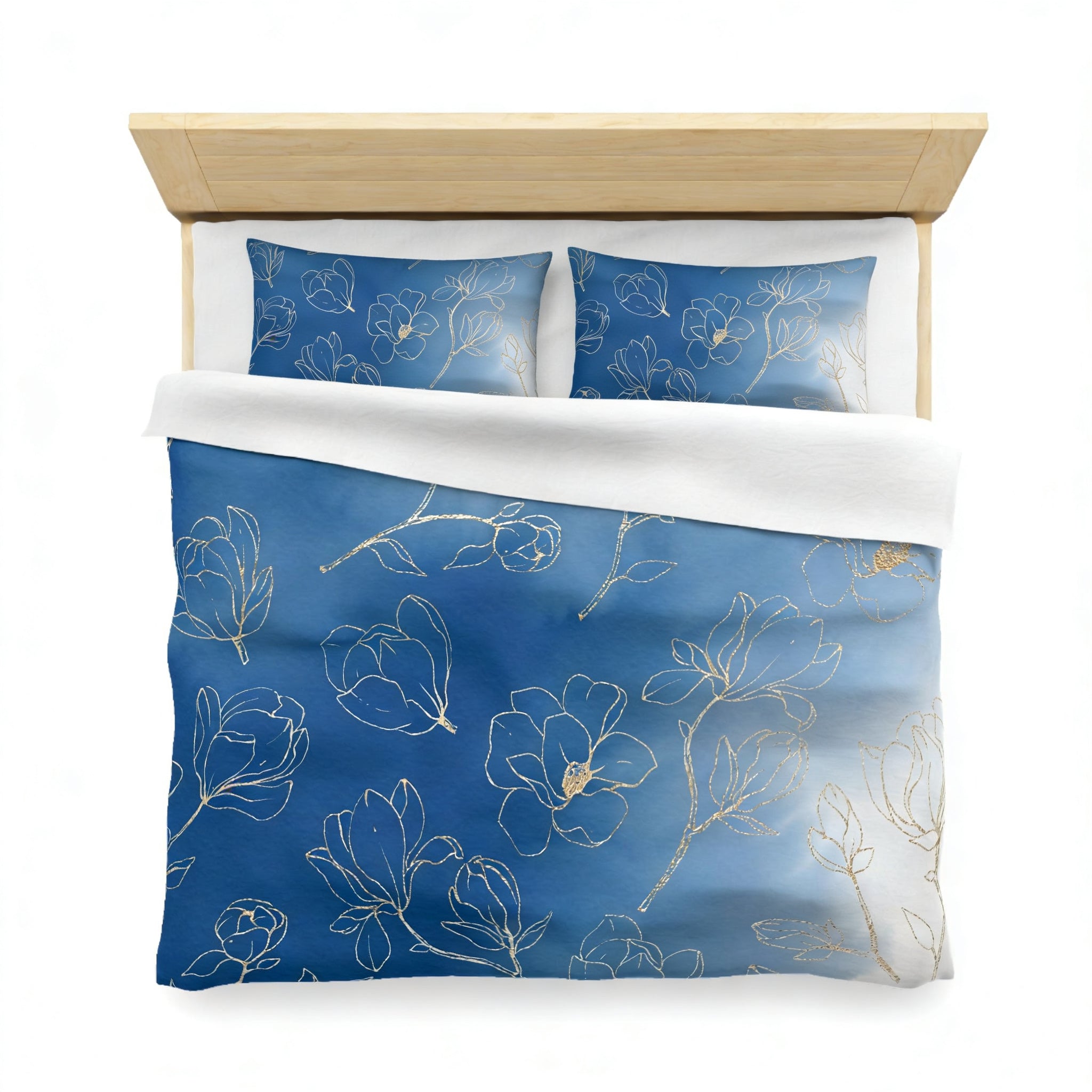 a neatly made bed with a blue and white floral patterned comforter and matching pillows.