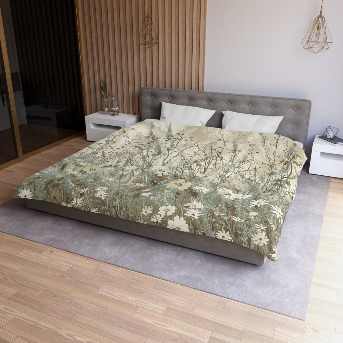 a modern bedroom with a large bed, a gray headboard, and a wooden floor. The bed is covered in a floral print comforter, and there are two white pillows on the bed. The room has a minimalist and clean design, with a white nightstand and a pendant light hanging above the bed.