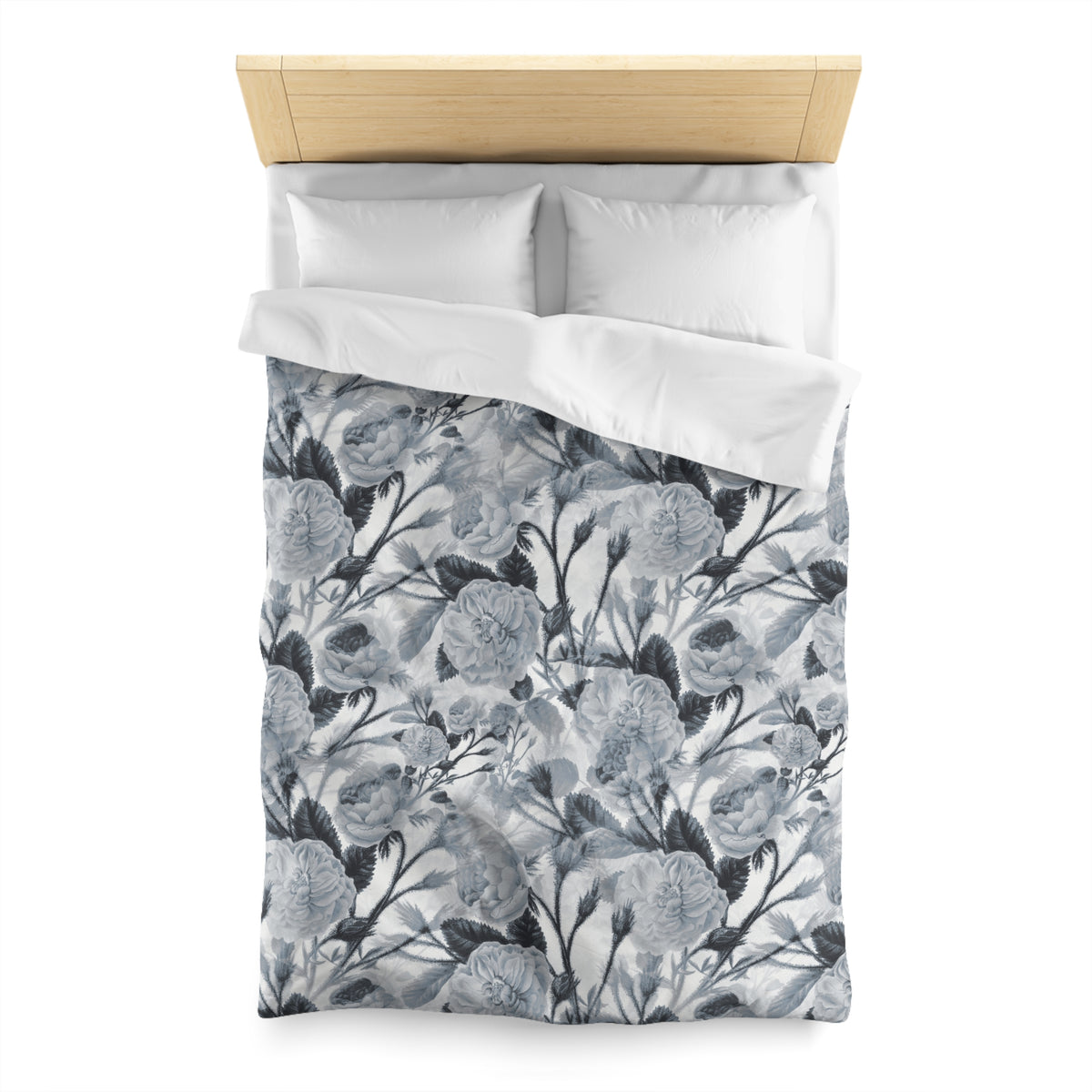 a neatly made bed with a floral patterned comforter and pillows.