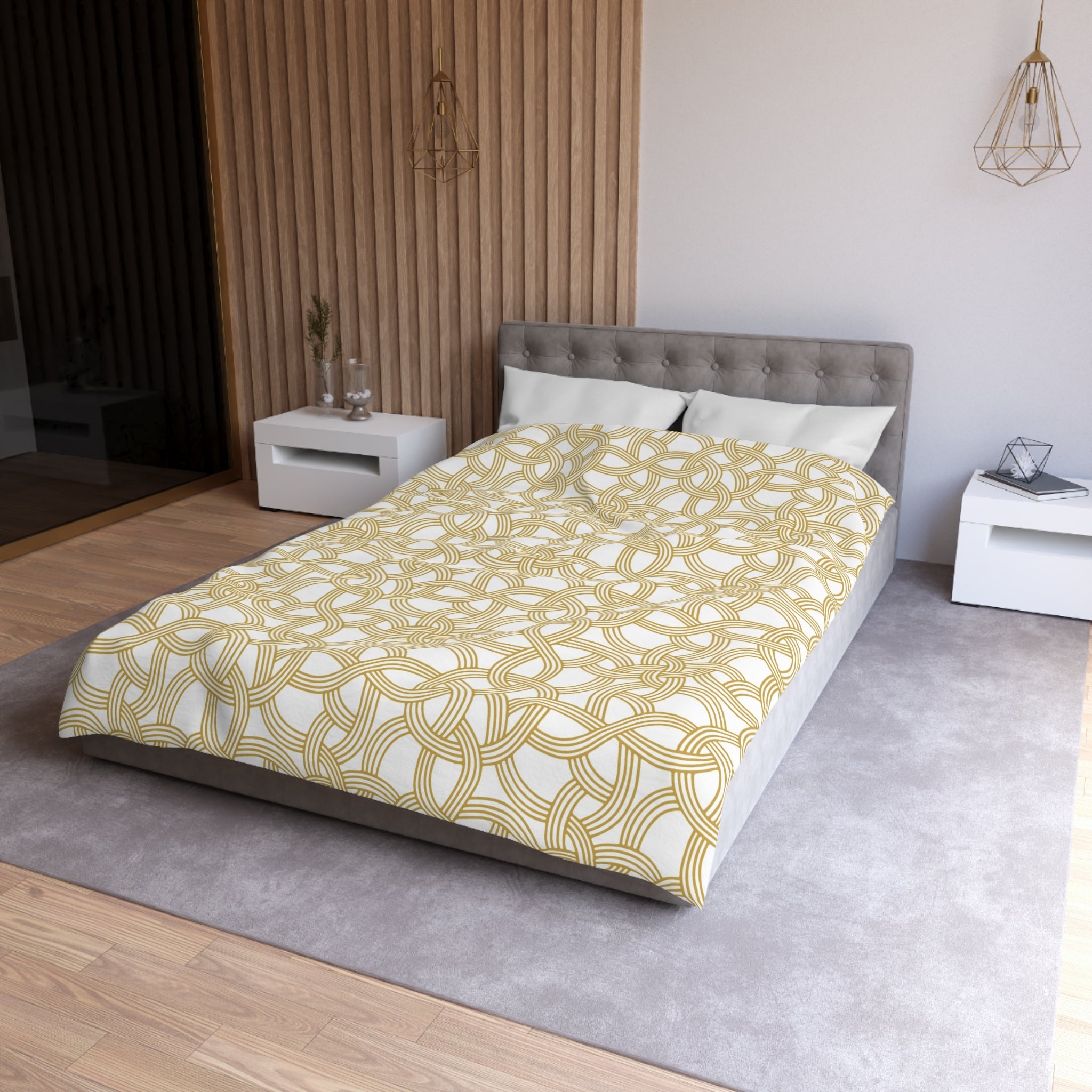 a modern bedroom with a gray tufted headboard, a yellow and white patterned comforter, and a gray nightstand on the right side of the bed.