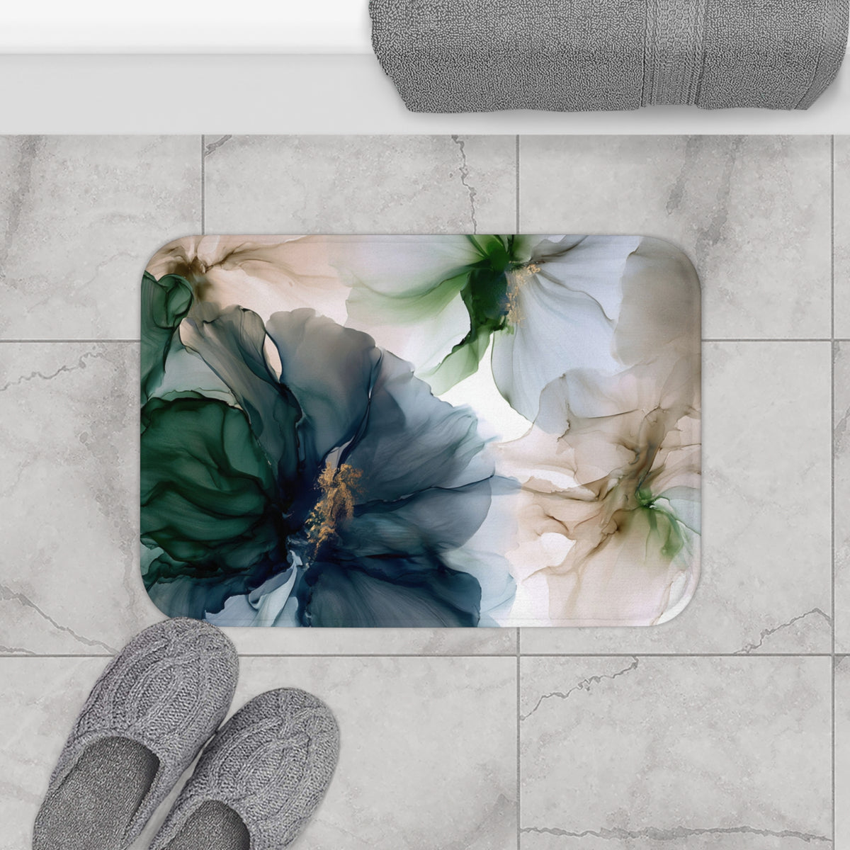 a pair of gray slippers sitting on top of a bathroom rug