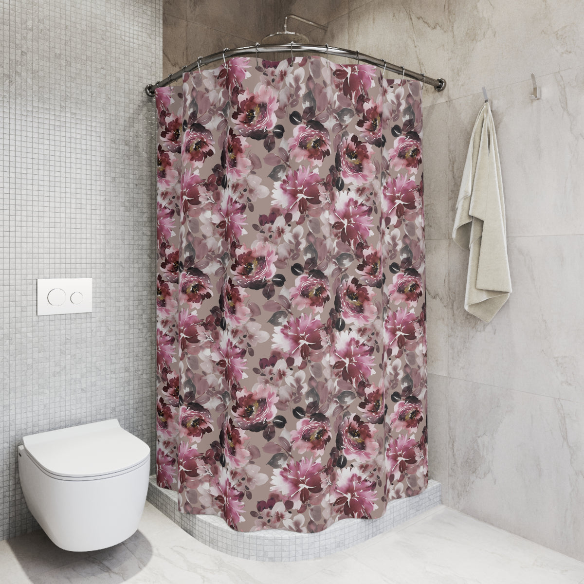 a bathroom with a shower curtain featuring a floral pattern in shades of pink and purple. The shower curtain is hanging from a rod next to a towel. The bathroom also includes a toilet and a tiled wall.