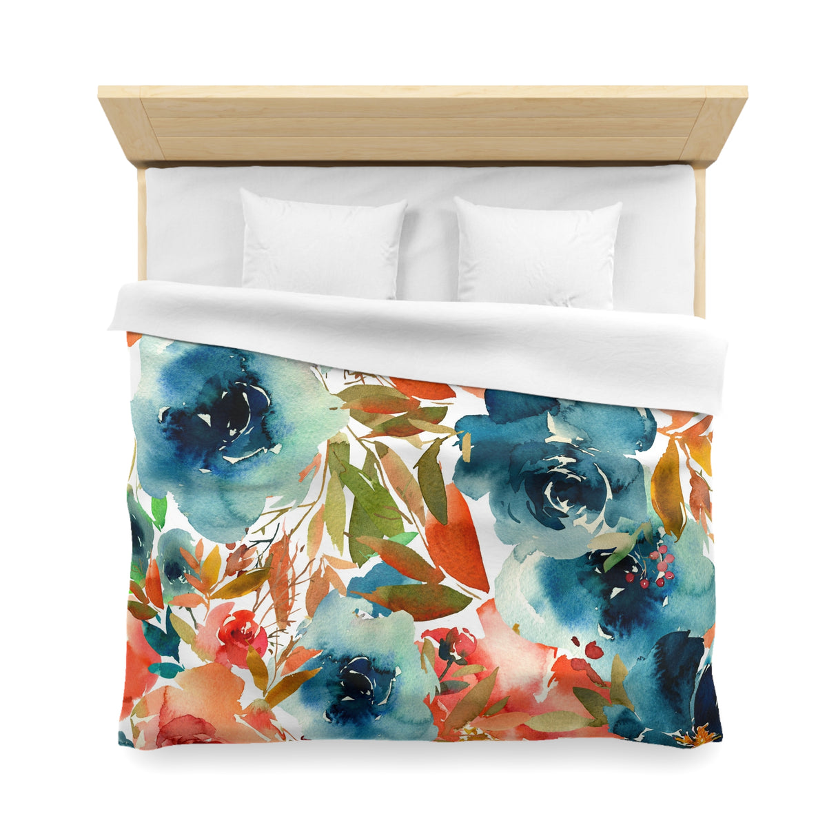 a bed with a colorful floral print duvet cover and white pillows.