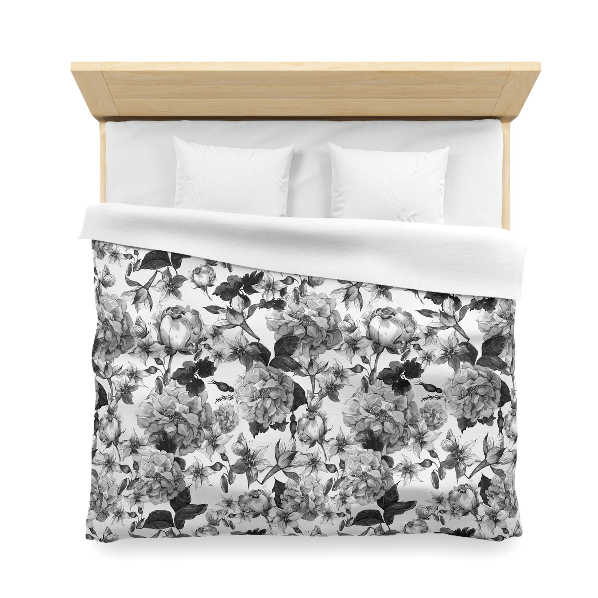 a neatly made bed with a floral print duvet cover and two white pillows.