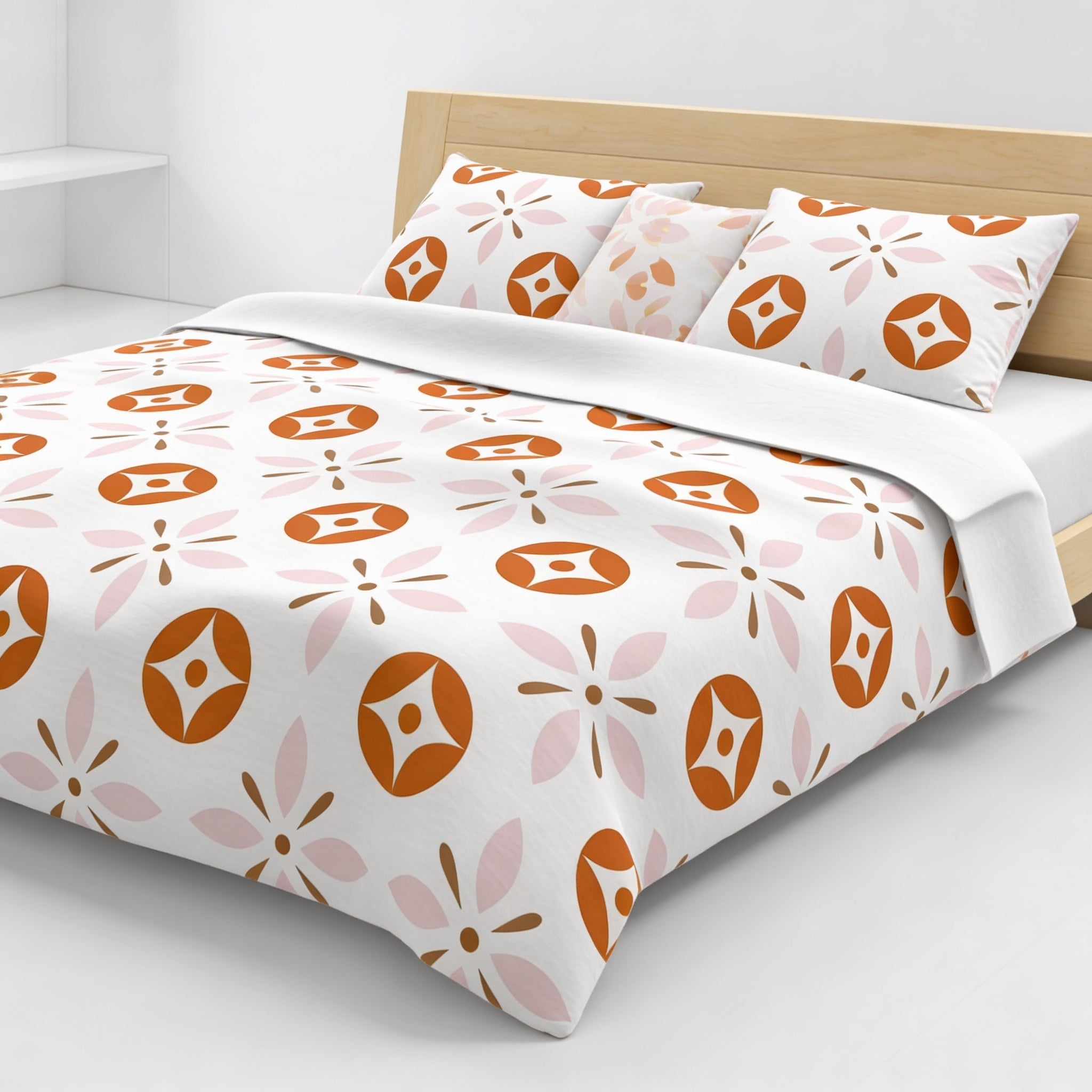 a bed with a white comforter and pillows, featuring a repeating pattern of orange and pink flowers on the comforter and pillows.