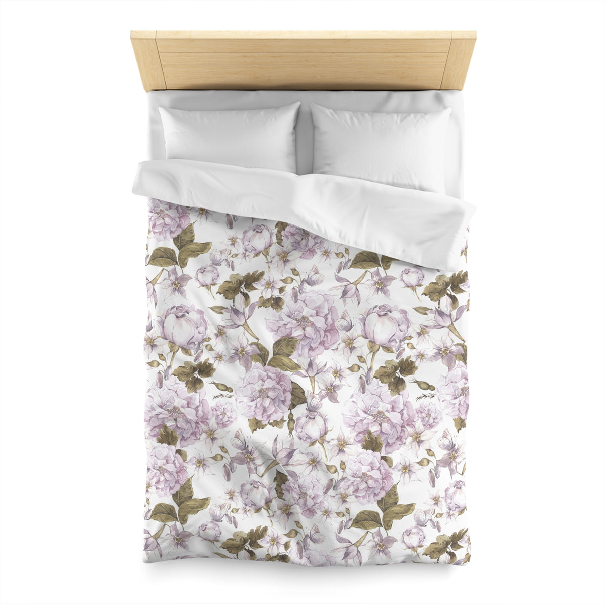 a bed with a floral print duvet cover and pillows.