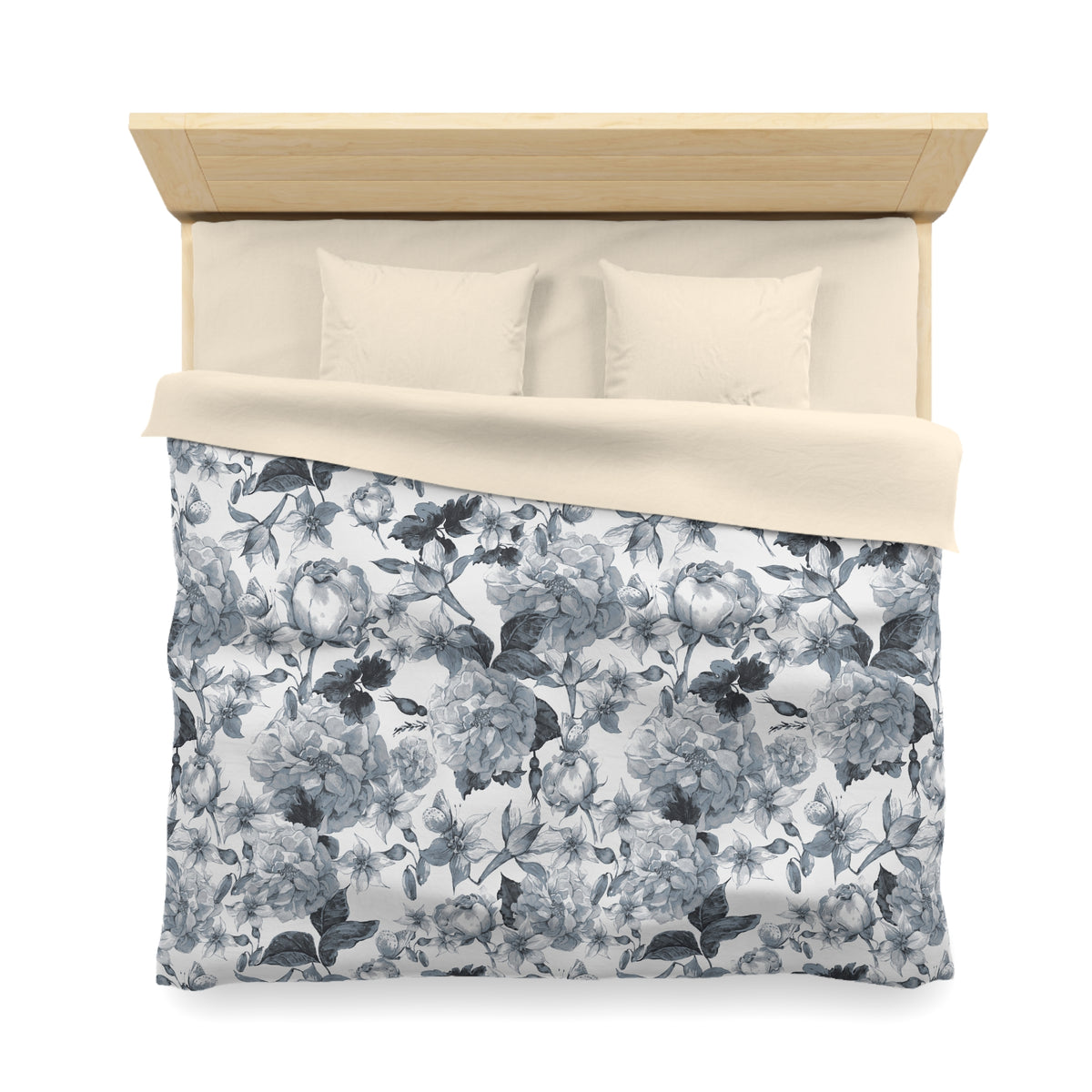 a neatly made bed with a floral print comforter and pillows.