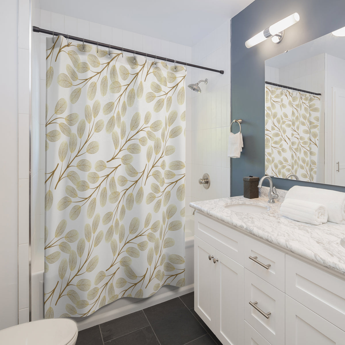 a modern bathroom with a white vanity, a shower curtain with a leaf pattern, and a mirror above the sink.