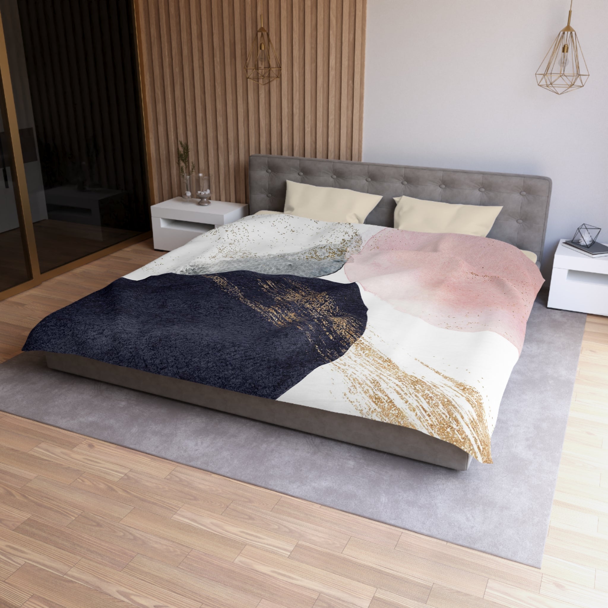 a modern bedroom with a large bed, a gray headboard, and a colorful abstract patterned comforter. The room has a wooden floor and white walls, creating a clean and minimalist aesthetic.