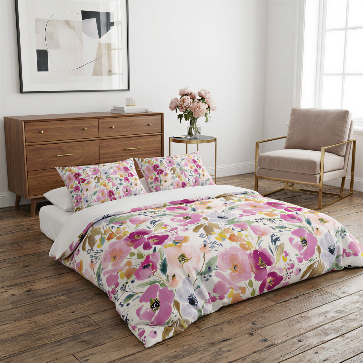 a bedroom with a floral-patterned bedspread, a wooden dresser, a vase of flowers, and a chair.