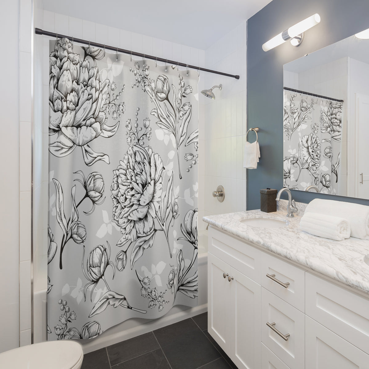 a modern bathroom with a white vanity, a shower curtain with a floral pattern, and a mirror above the vanity.