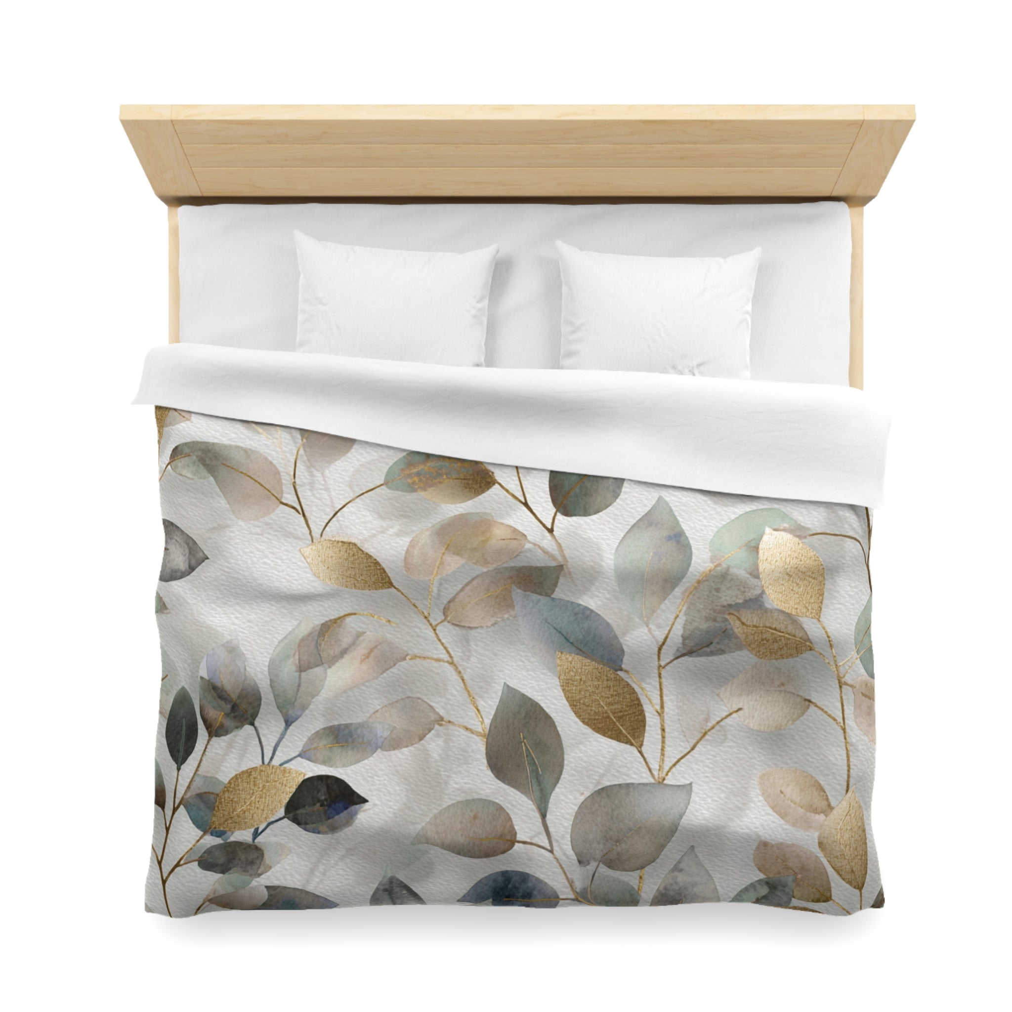 a neatly made bed with a white comforter and a patterned duvet cover featuring a leaf design in shades of green, gray, and brown.