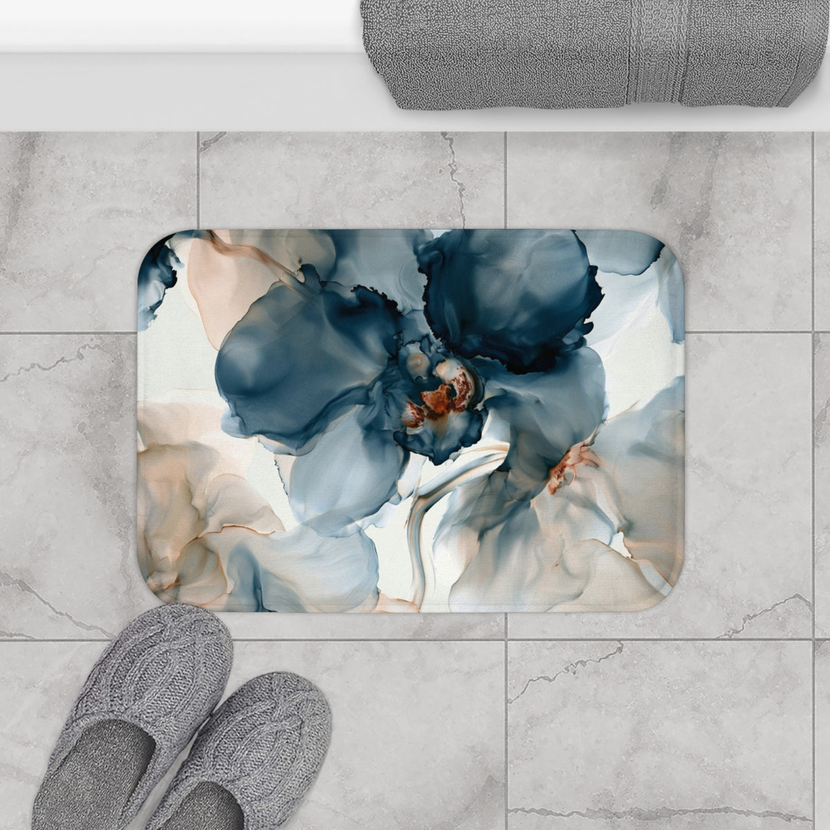 a bathroom rug with a blue flower on it
