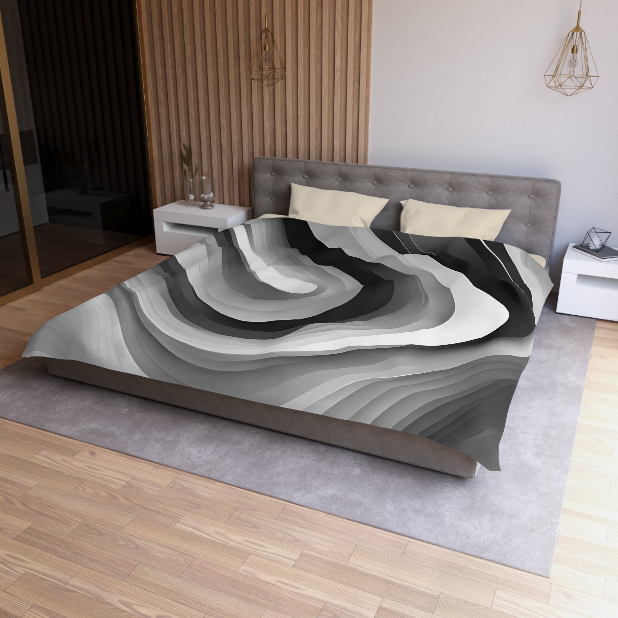 a modern bedroom with a large bed, a gray headboard, and a gray and white abstract patterned comforter. The room has a wooden floor and white walls, creating a minimalist and elegant design.