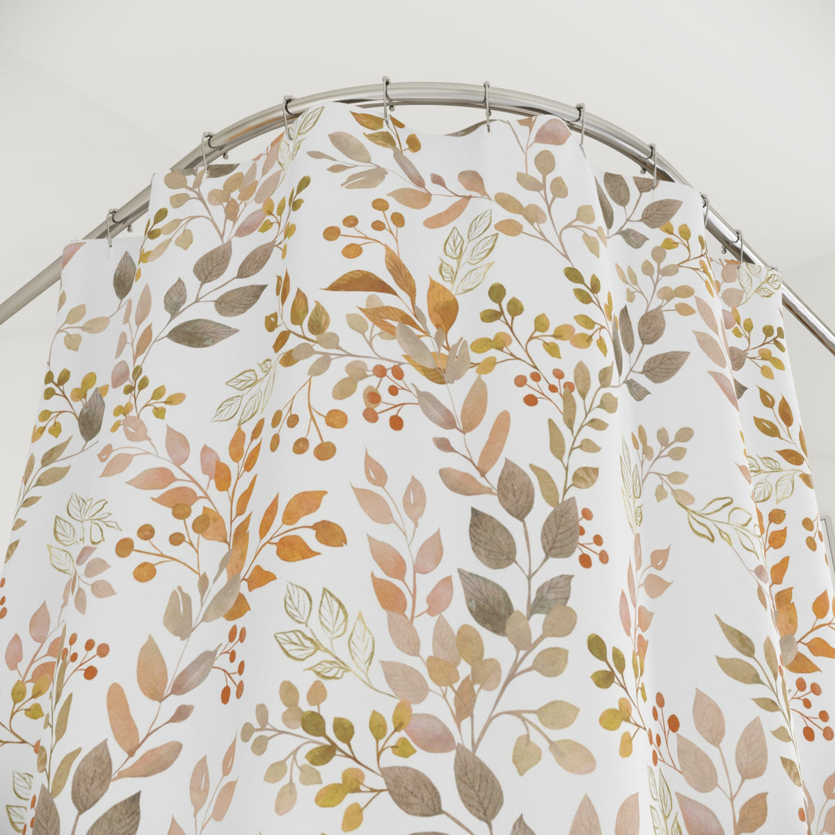 a shower curtain with a floral pattern of leaves and berries hanging from a curved metal rod.
