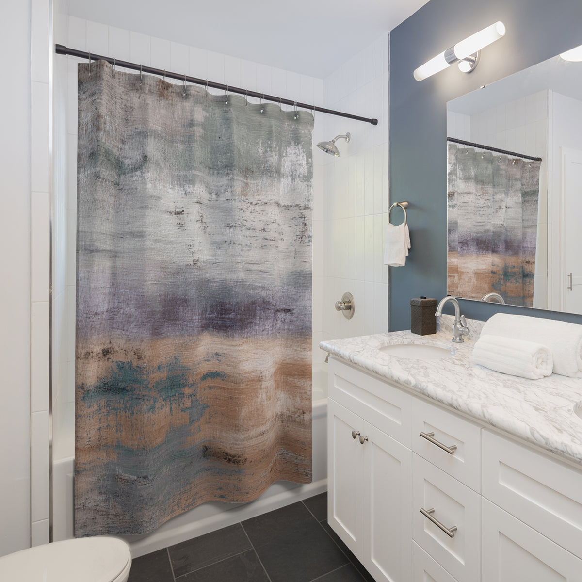 a modern bathroom with a white vanity, a shower curtain featuring a colorful abstract design, and a large mirror above the vanity.