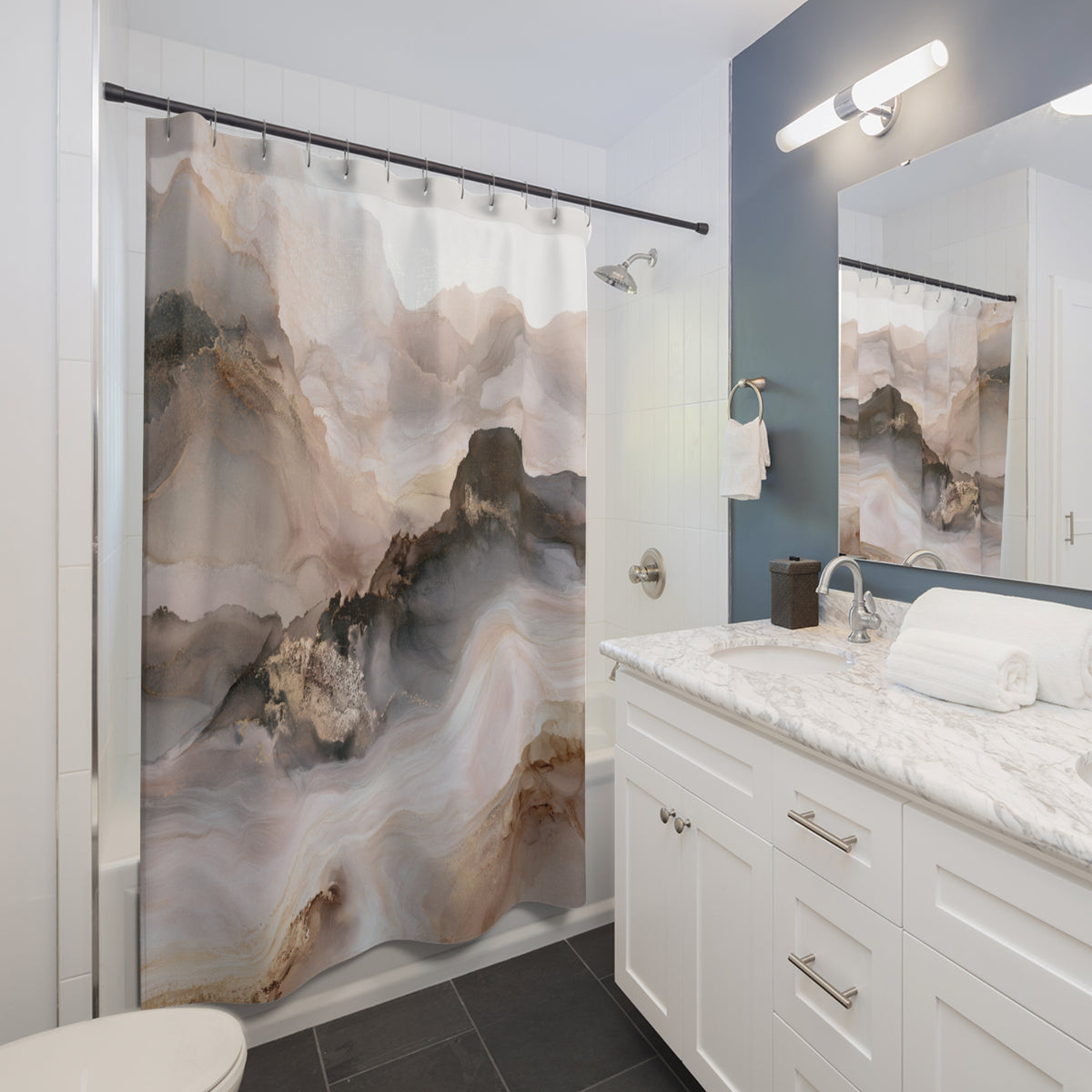 a modern bathroom with a large shower curtain featuring a mountain landscape design. The bathroom has white cabinets, a marble countertop, and a large mirror.