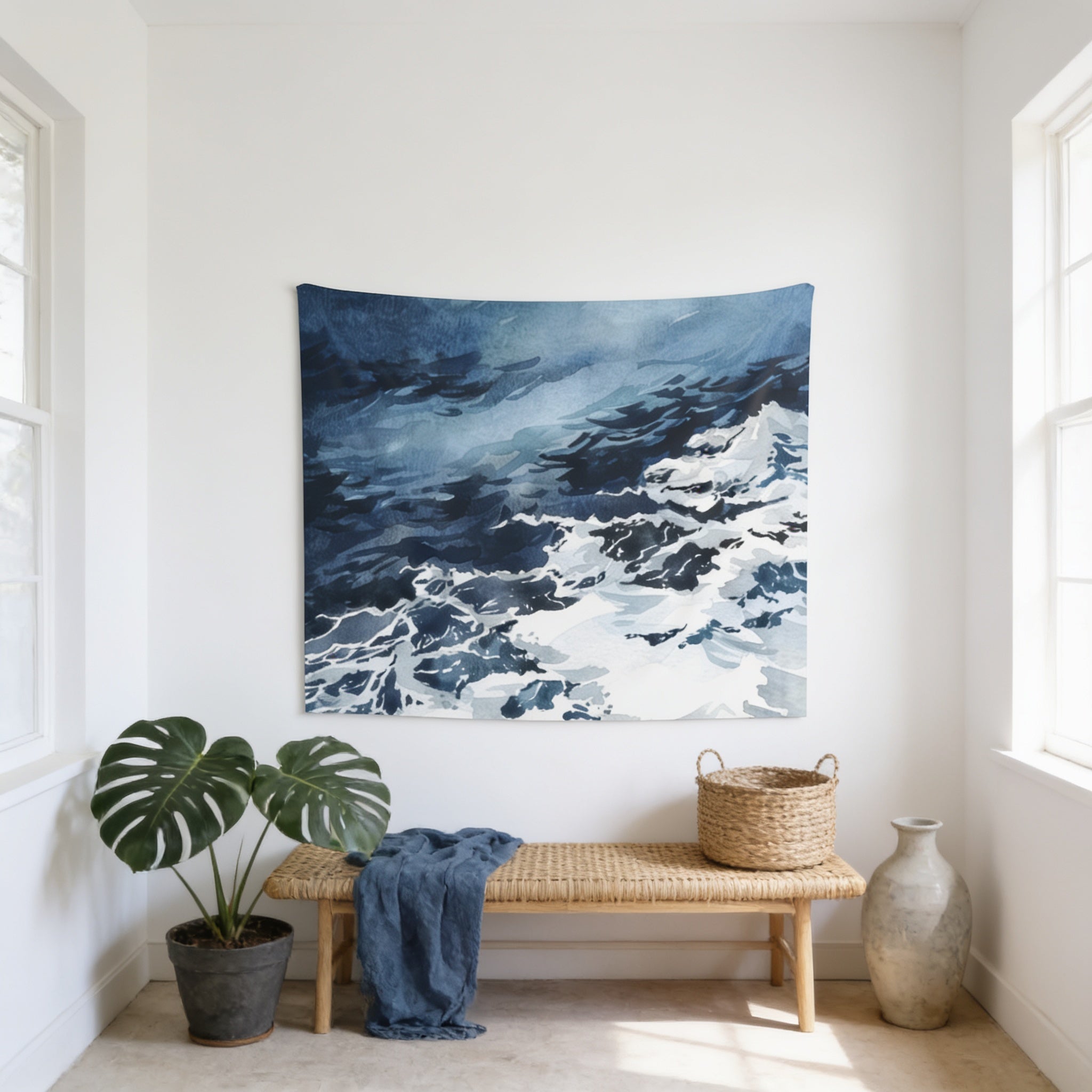 a serene indoor setting with a large blue and white tapestry hanging on the wall, a woven bench, a potted plant, and a woven basket.